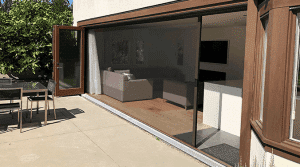 Large retractable screen door creating seamless indoor-outdoor living