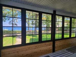 Bright and airy 3-season vinyl sunroom with natural wood ceiling