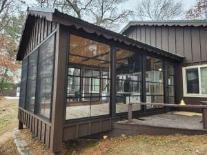Rustic 3-season vinyl sunroom with wood details and full-height windows