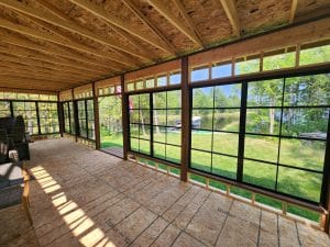 Interior of a vinyl 3-season sunroom with wood ceiling and lake view in Minnesota