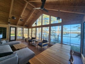 Raised 3-season sunroom with large vertical vinyl windows for panoramic views