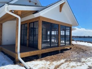 3-season vinyl sunroom with black frames overlooking the lake in Brainerd, Minnesota