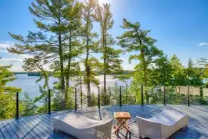 Topless glass railing preserving the view from a lakefront cabin deck