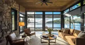 Lakeside sunroom with 4-track vinyl windows and a ceiling fan