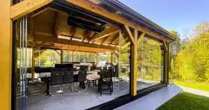 Novasun Panoramic glass walls stacked open around a timber outdoor room