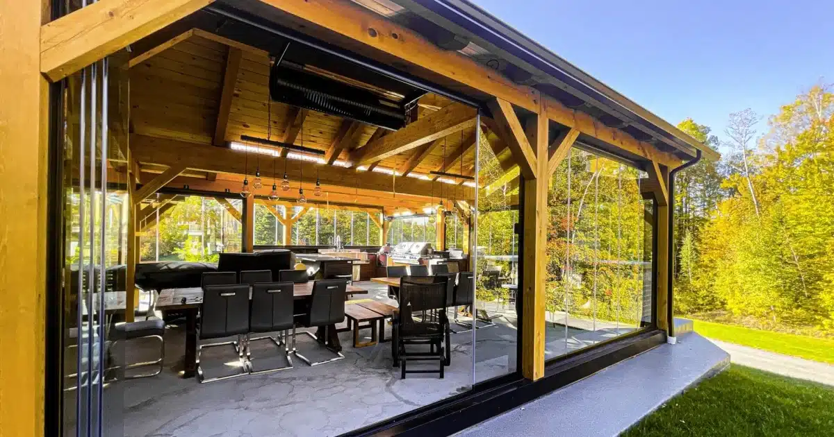 Novasun Panoramic glass walls stacked open around a timber outdoor room