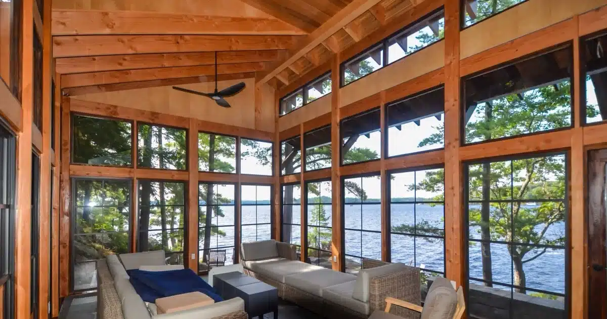 WeatherMaster screen windows surrounding a furnished lake porch with a wide water view
