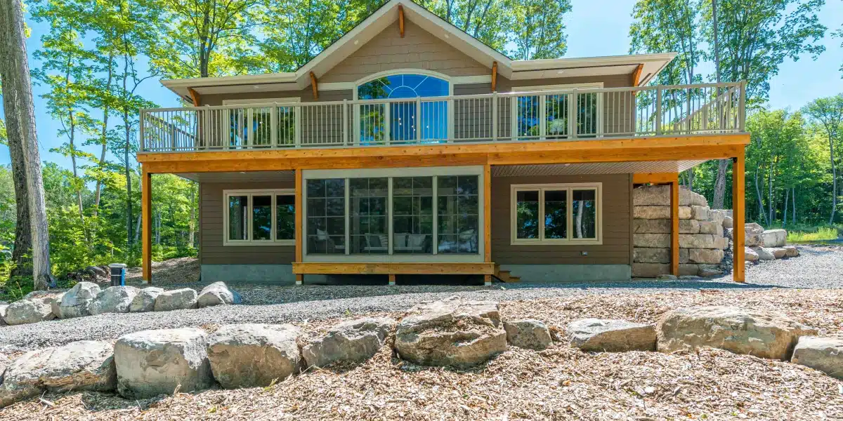 Home with an enclosed porch built beneath a raised deck