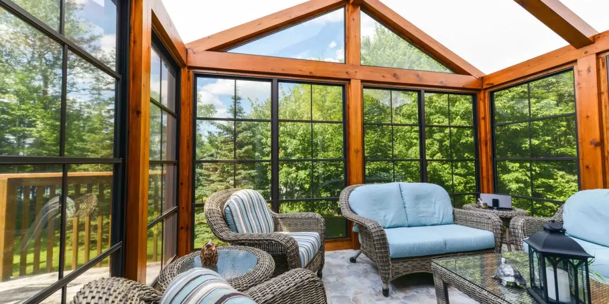 Black-framed WeatherMaster window panels surrounding a wood cabin porch
